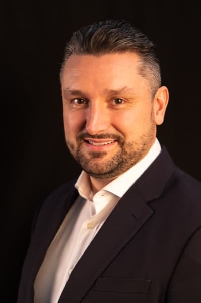 Executive portrait of Alex James, Founder of PROPATIR, RICS qualified Chartered Surveyor with expertise in UK commercial real estate investment and asset management
